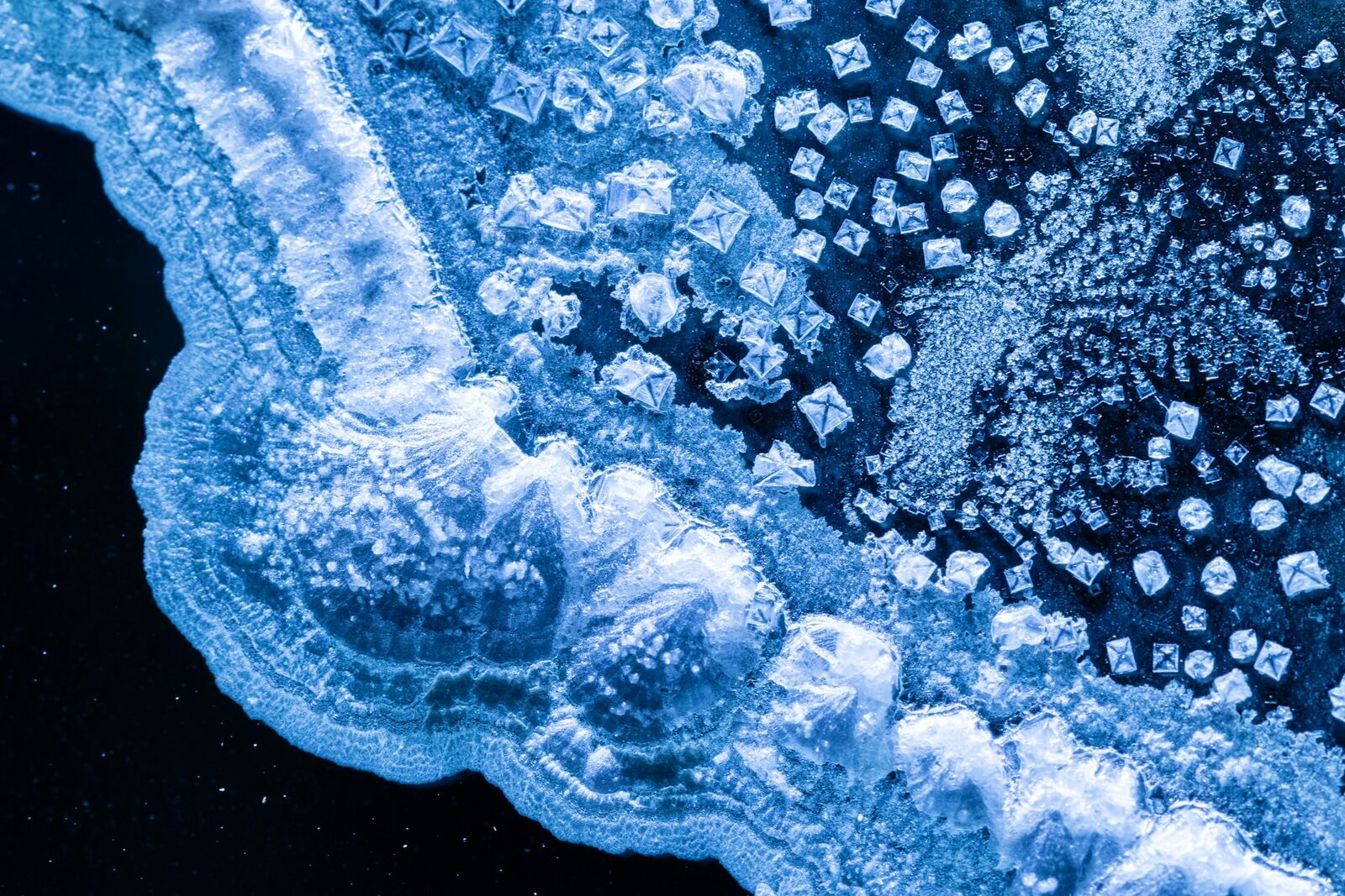 Aerial view of ice structures on water — showing the crystalline formation and frozen surface detail.